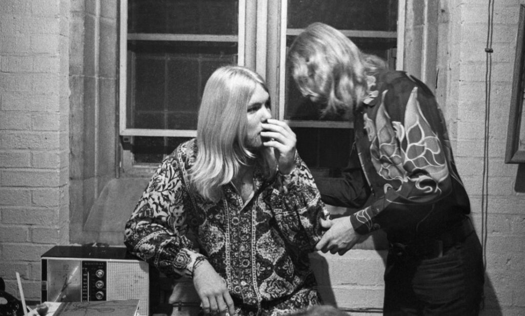Duane Allman chats with his brother Greg Allman backstage before the Allman Brothers' performance