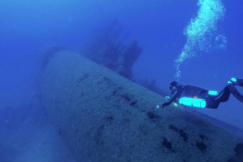Diver investigating submarine