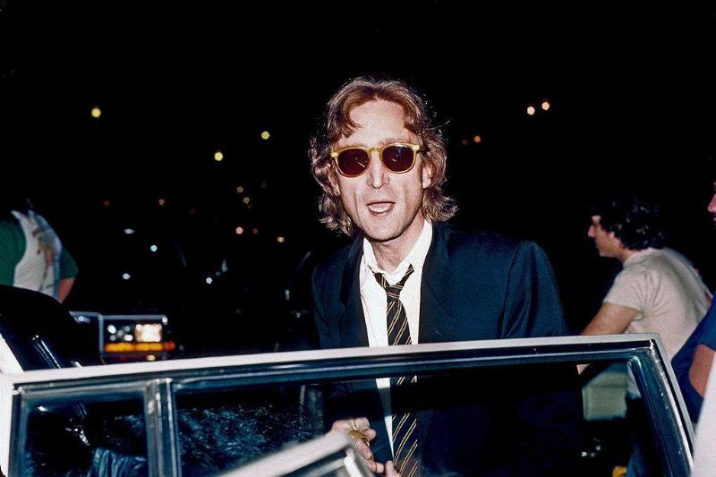 John Lennon getting into a car