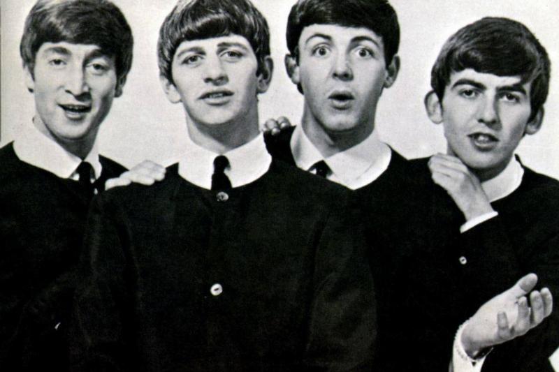 The Beatles pose in their schoolboy look.