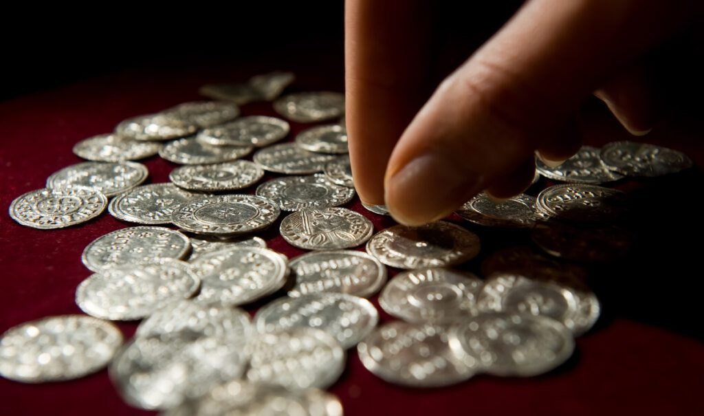 Silver coins from the Vale of York viking hoard are displayed at a press conference to unveil the newly conserved hoard at the British Museum