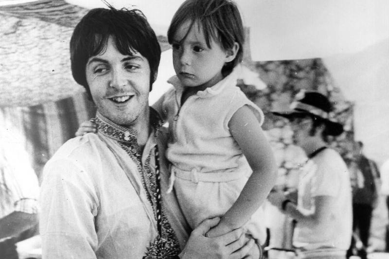 Paul McCartney holds young Julian.