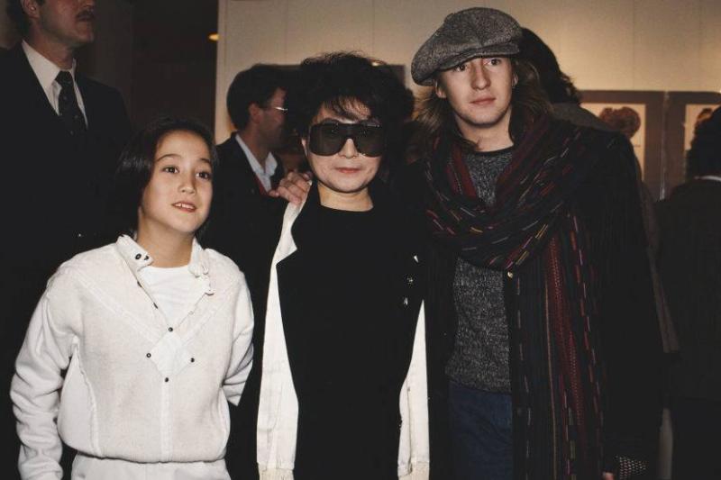 Teenage Julian and young Sean Lennon put their arms around Yoko Ono.