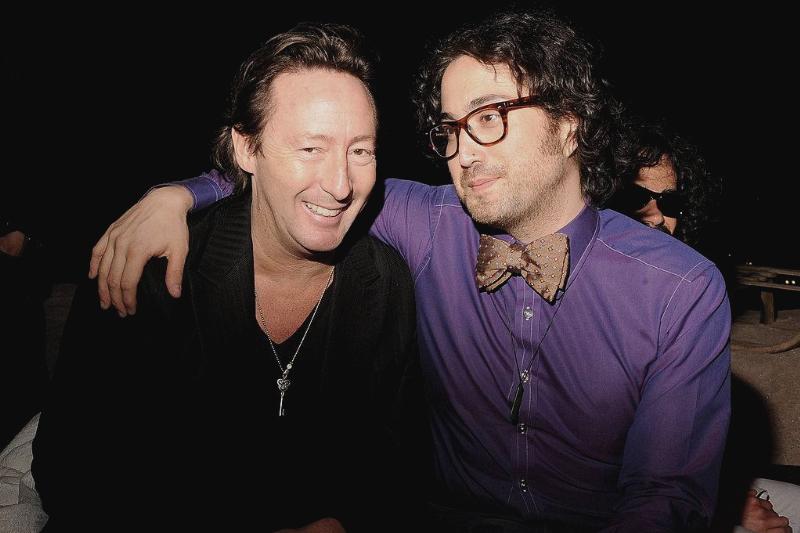 Sean Lennon grins with his arm around a smiling Julian.