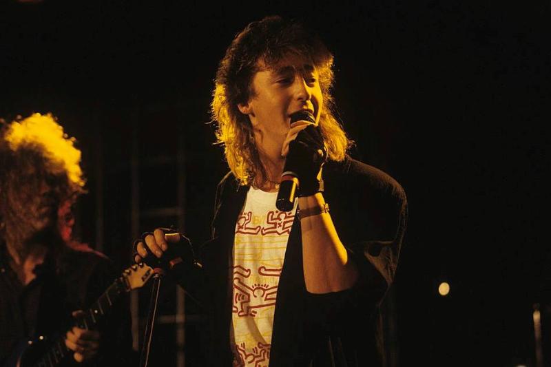 Julian sings onstage.