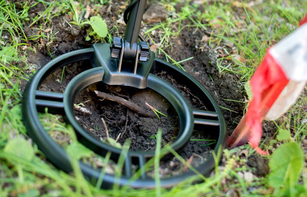 A metal detector being held over a find in Lower Saxony