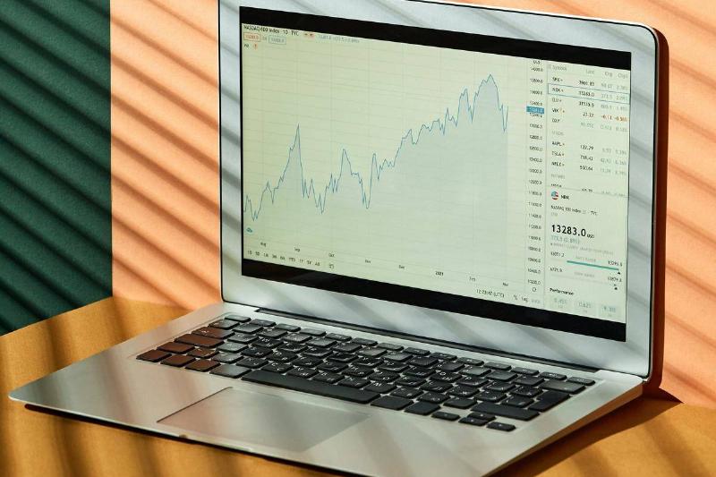 Laptop with stock market screen on it.