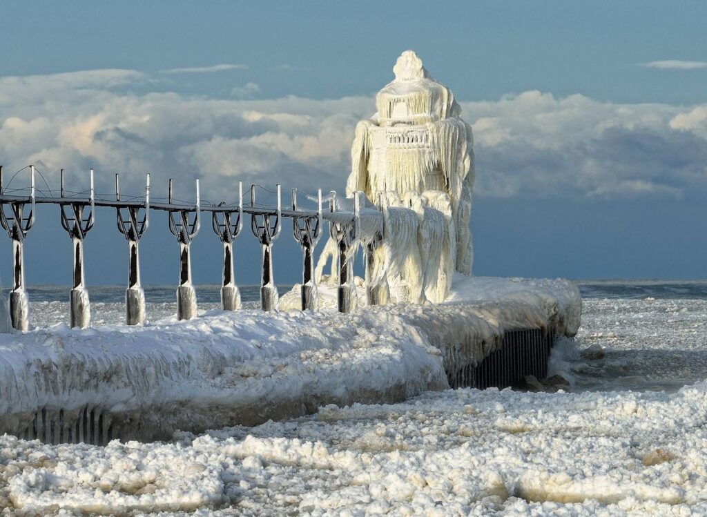A frozen lighthouse is covered in ice on a lake in St. Joseph, Michigan.