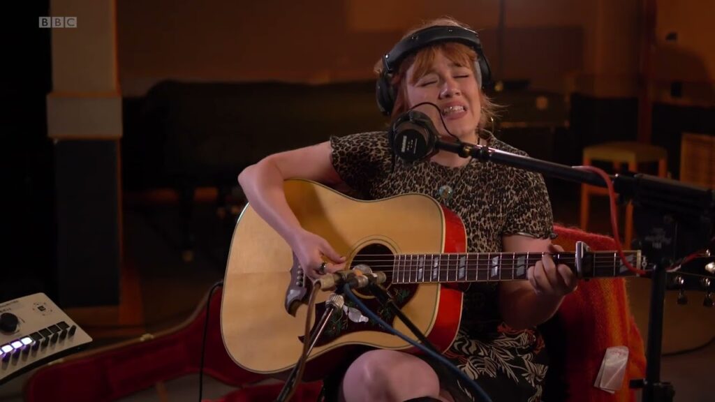 Watch CMAT Cover Daniel Johnston’s “Joy Without Pleasure” On Jo Whiley Sofa Sessions