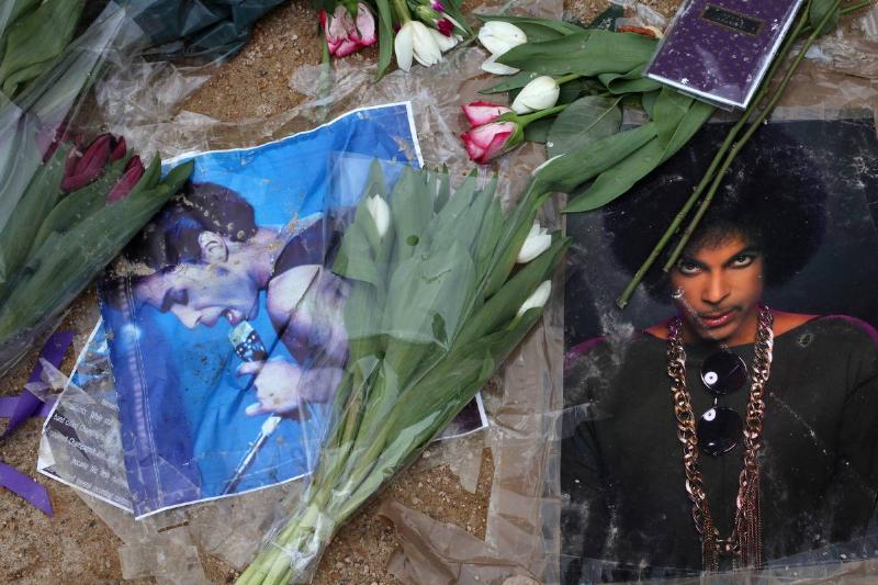 Flowers, notes of condolences, and images of musician and recording artist Prince are left at a makeshift memorial.