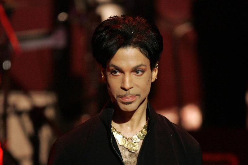 The musician Prince walks on stage to receive an award.